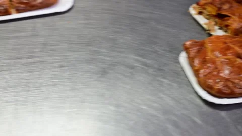 Professional baker cutting and serving a slice of galician empanada Stock-Footage 330428708