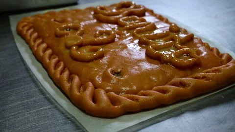 Professional baker cutting and serving a slice of galician empanada Stock Footage 330429026
