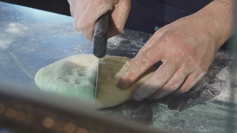 Professional baker cutting dough at the kitchen Video stock 86162238