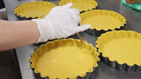 Professional Baker Docking Raw Tart Dough in Fluted Tins Stock Footage 337751170