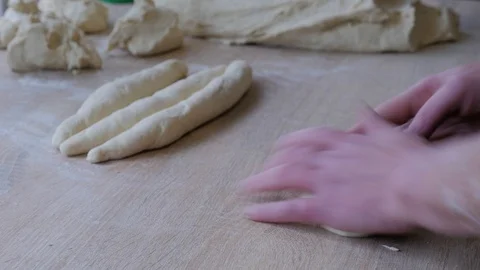 Professional baker is forming pieces of dough for baking bread in bakery Stock Footage 108633554