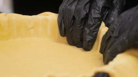 Professional Baker Hands in Black Gloves Shaping Raw Pie Crust Dough, Close-up Stock Footage 337751439