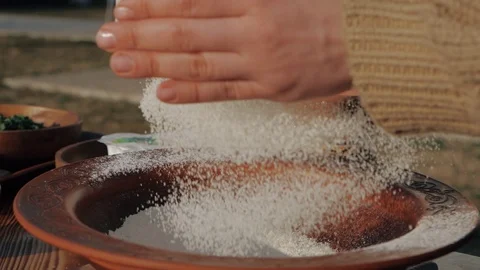 Professional baker hands sift flour through a wooden sieve on the table against Stock Footage 129786276