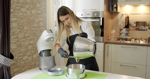Professional baker preparing the cake batter, making cream. Wide shot Stock Footage 140471426