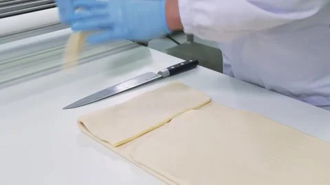 Professional Baker Preparing Puff Pastry Dough on Industrial Sheeter in Food Fac Stock Footage 337751409