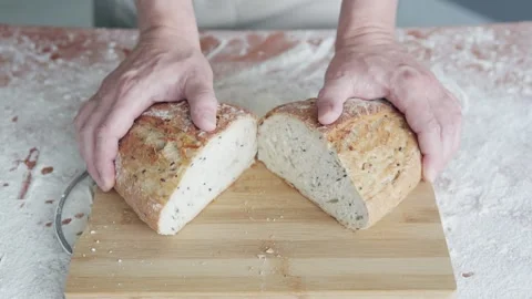 A professional baker presents freshly cut and crispy bread. Video stock 301599982