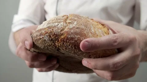 Professional baker quality checker breaking freshly baked bread Video stock 198736064