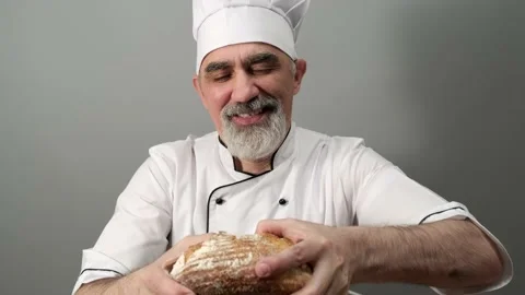 Professional baker quality checker breaking freshly baked bread. Video stock 198736114