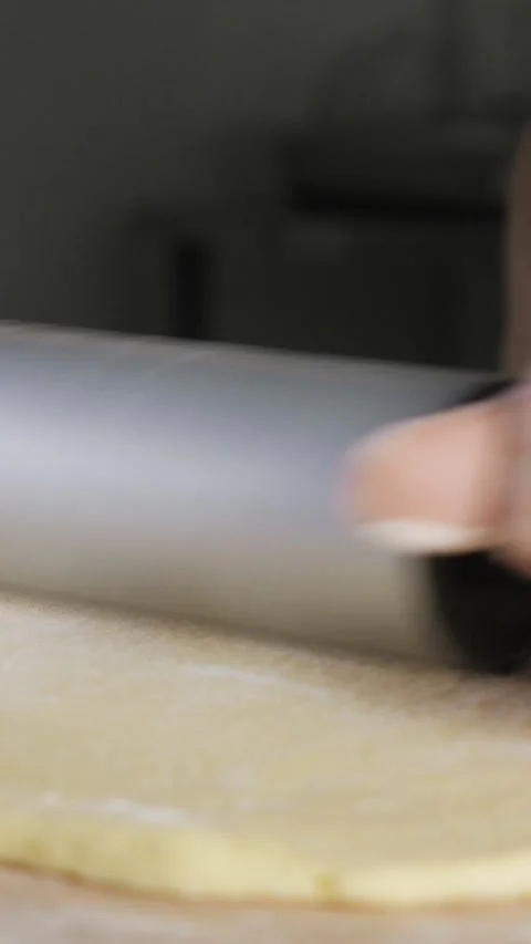 Professional baker rolling dough with a rolling pin Stock Footage 341444261