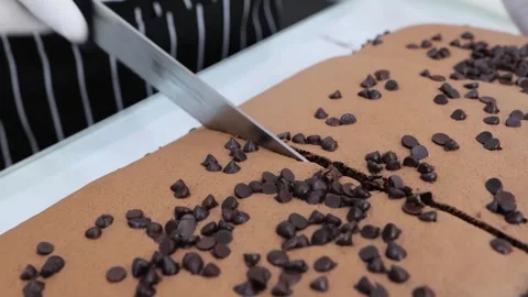 Professional Baker Slicing Freshly Baked Giant Chocolate Castella Cake with Choc Stock Footage 331780296