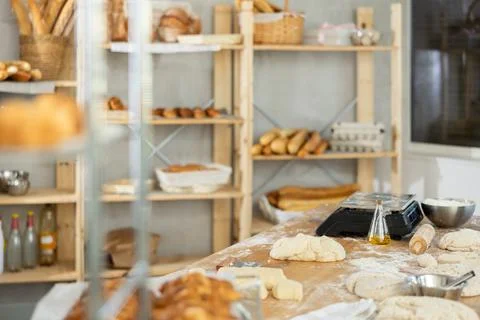 Professional bakery kitchen with work table, bread bun baking in deck, stuff Foto stock