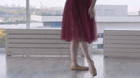 Professional ballet dancer makes battement tendu against high window background Stock Footage 96436495