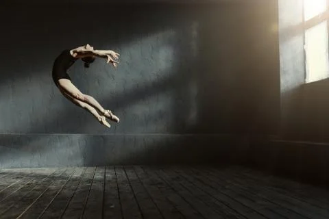 Professional ballet dancer performing in the dark lighted room Foto stock