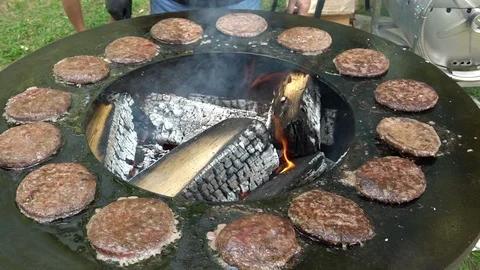 Professional barbecue chef baking meat for burgers on grill. Stock Footage 112545936