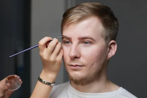 Professional barber doing threading procedure and correcting shape of eyebrows Stock Photos