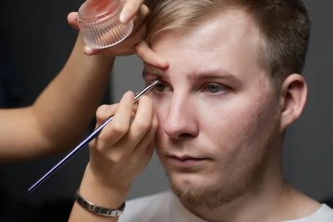 Professional barber doing threading procedure and correcting shape of eyebrows Stock Photos