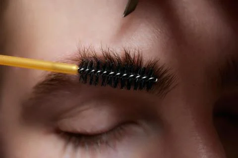 Professional barber doing threading procedure and correcting shape of eyebrows Stock Photos