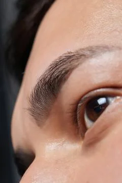 Professional barber doing threading procedure and correcting shape of eyebrows Stock Photos