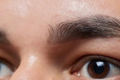 Professional barber doing threading procedure and correcting shape of eyebrows Stock Photos
