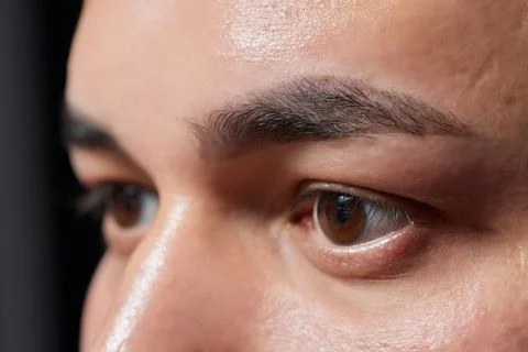 Professional barber doing threading procedure and correcting shape of eyebrows Stock Photos