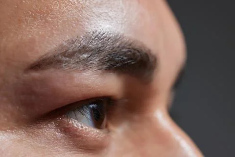 Professional barber doing threading procedure and correcting shape of eyebrows Stock Photos