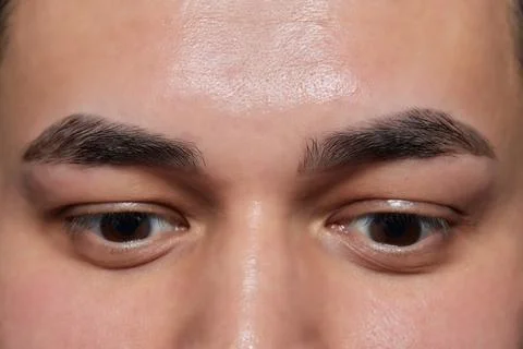 Professional barber doing threading procedure and correcting shape of eyebrows Stock Photos