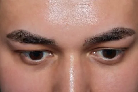 Professional barber doing threading procedure and correcting shape of eyebrows Stock Photos
