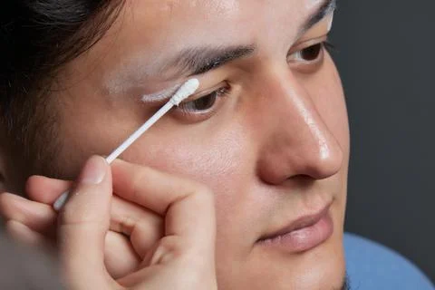 Professional barber doing threading procedure and correcting shape of eyebrows Stock Photos