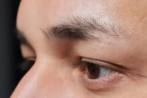 Professional barber doing threading procedure and correcting shape of eyebrows Stock Photos