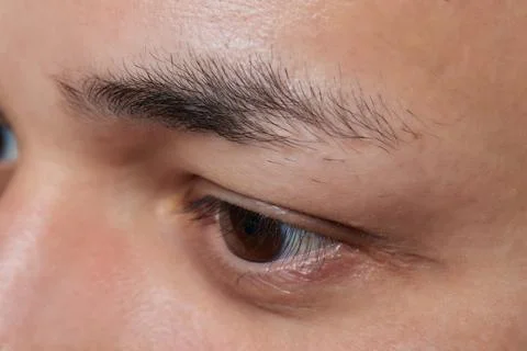 Professional barber doing threading procedure and correcting shape of eyebrows Stock Photos