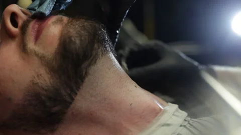Professional Barber Shaves Customer Beard With Straight Razor. Stock Footage 139765266
