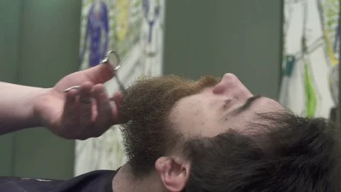Professional Barber Trim Beard of Young man Stock Footage 74084899