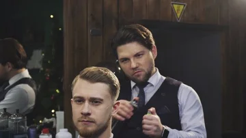 Professional barber working burning fire hair treatment on his client Stock Footage 85750957