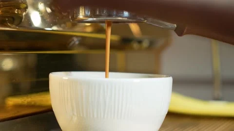 Professional barista makes coffee, ready-made coffee is poured into a cup from a Stock Footage 195446247