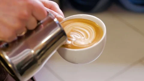 Professional barista making pouring stream milk with beautiful latte art pattern Stock Footage 106463484