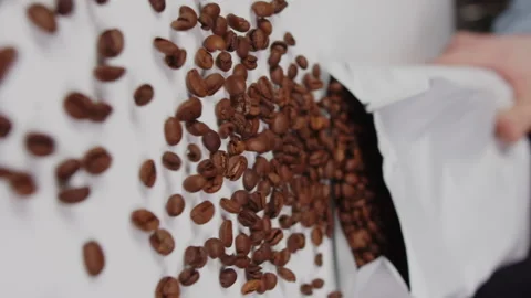 Professional barista opens and throws a white bag of coffee beans on the table Stock Footage 168445179