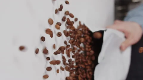 Professional barista opens and throws a white bag of coffee beans on the table Video stock 169056582