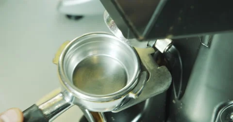 Professional barista worker man using grinder machine to grind coffee beans Stock Footage 136330371