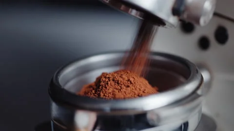 Professional barista worker use grinder machine to grind fresh coffee beans for Stock Footage 153057447