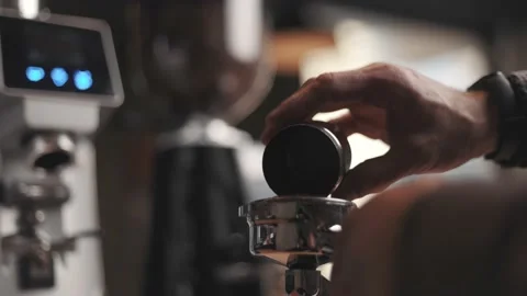 Professional barista worker use grinder machine to grind coffee Stock Footage 188908558