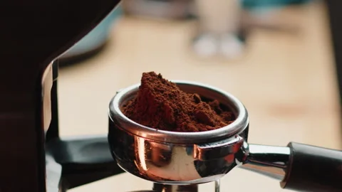 Professional barista worker use grinder machine to grind fresh coffee beans for Stock Footage 248686811