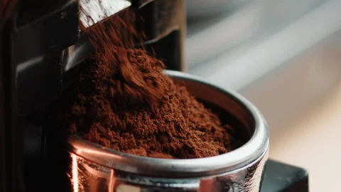 Professional barista worker use grinder machine to grind fresh coffee beans for Stock Footage 250134533