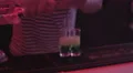 Professional barman pouring vodka in glasses of alcohol shots for bar guests HD Footage
