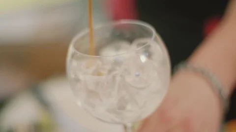 Professional barman stirs ice with a long spoon in a glass Stock Footage 127522899