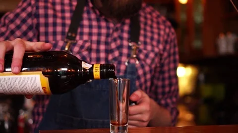 Professional bartender carefully pouring coffee liquor in small shot glass Stock Footage 103804778