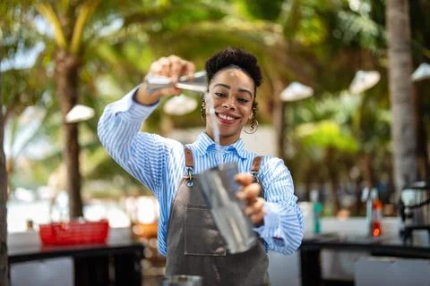 Professional bartender crafting a refreshing cocktail with expert mixing sk.. Фото