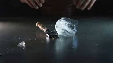 Professional bartender cuts an ice cube for a cocktail Stock Footage 87384170