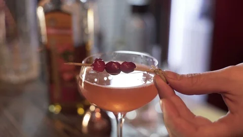 Professional bartender decorating cocktail with raspberry Stock Footage 96147536