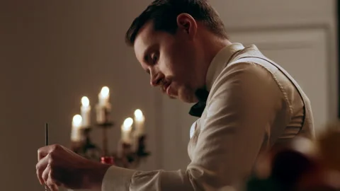 Professional bartender focused on stirring the liquid in a glass with a long spo Stock Footage 199462772