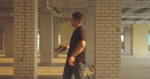 Professional bartender juggles bottles. The bartender is practice in hall at Video stock 154352895